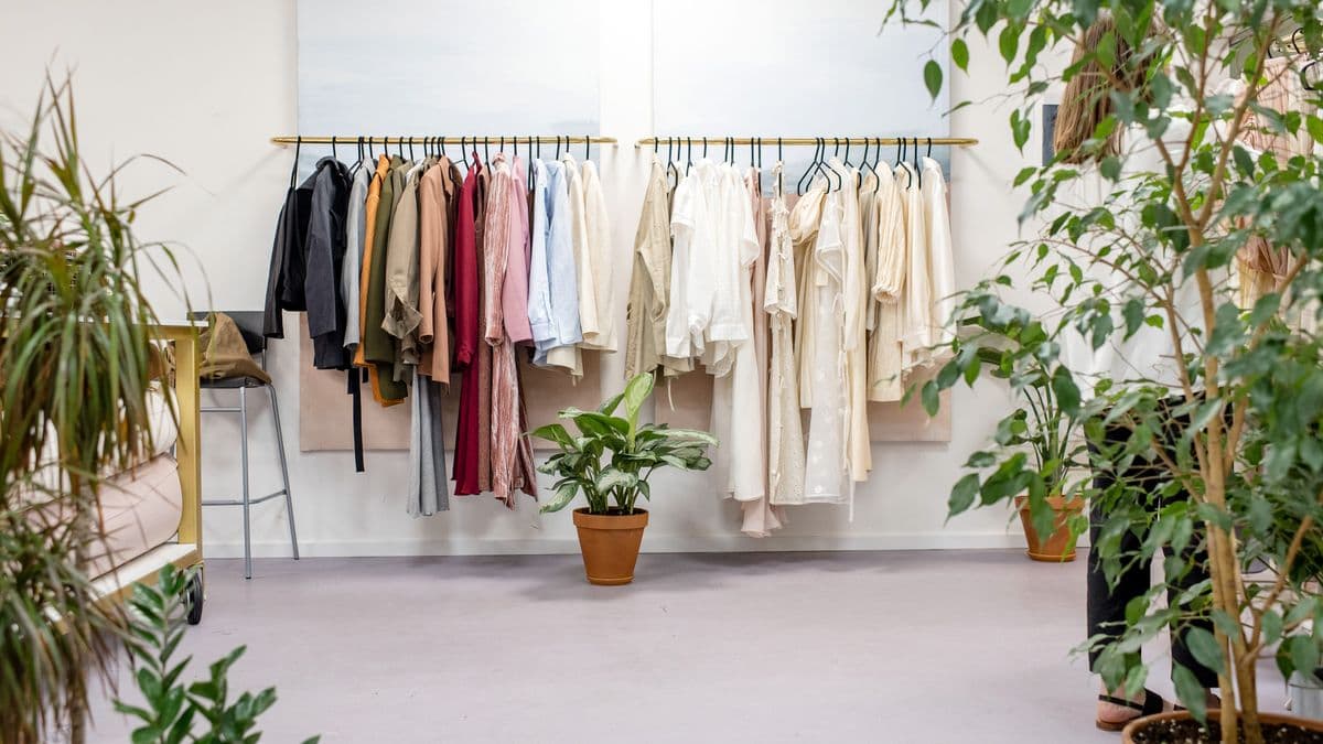 A bright fashion boutique with clothes on racks