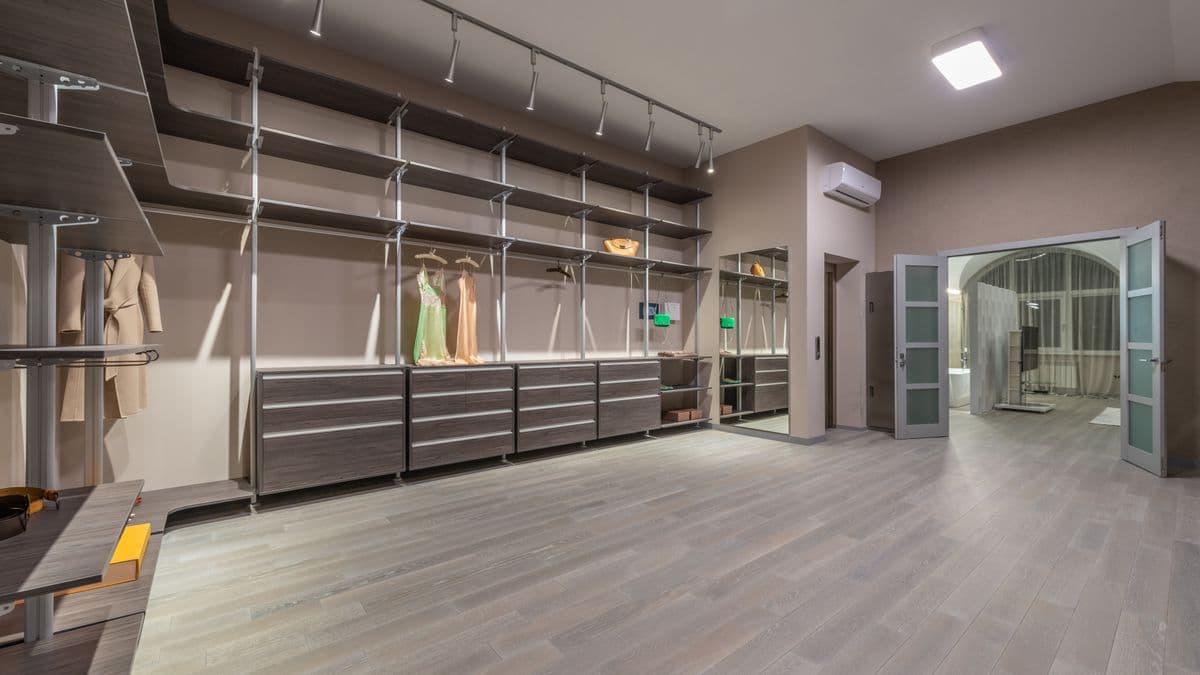 An elegant walk-in closet with dresses